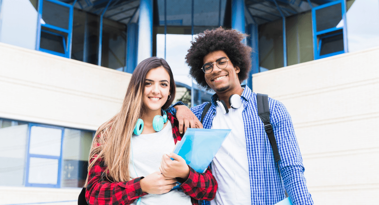 Happy young couple smiling portrait in front of university building